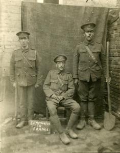 Three British artillerymen photographed in a makeshift studio near the front