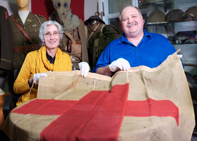 Wendy Lugg and Doug Buhler pose with the Gallipoli Red Cross Flag